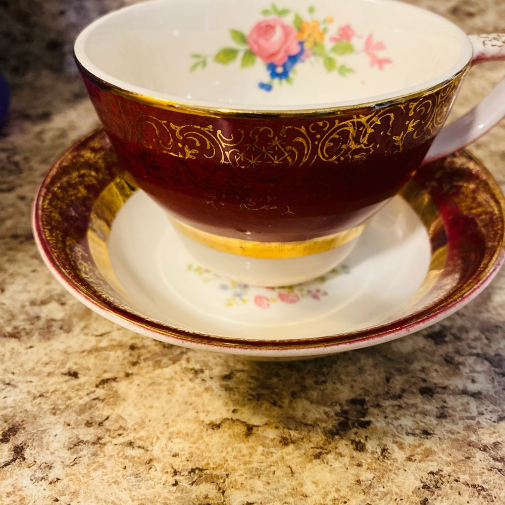 Elegant Red and Gold Floral Teacup and Saucer vintage has a small crack